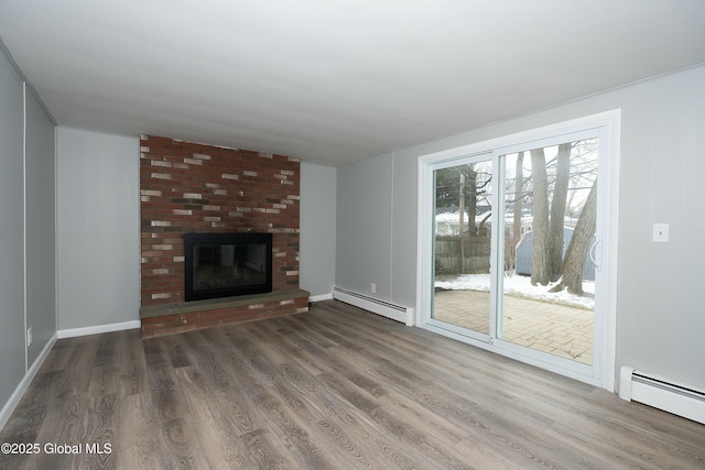 unfurnished living room with dark hardwood / wood-style flooring, a baseboard radiator, and a fireplace