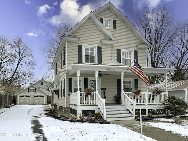 view of front of home featuring a garage, covered porch, and an outbuilding