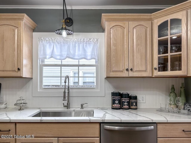 kitchen with light stone countertops, stainless steel dishwasher, decorative light fixtures, light brown cabinetry, and sink