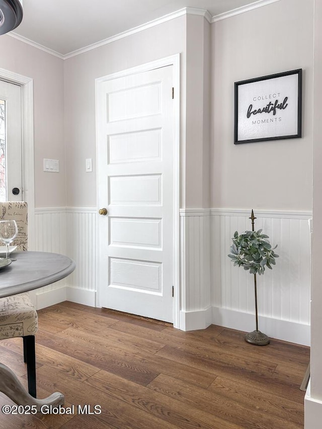 interior space with dark hardwood / wood-style flooring and crown molding