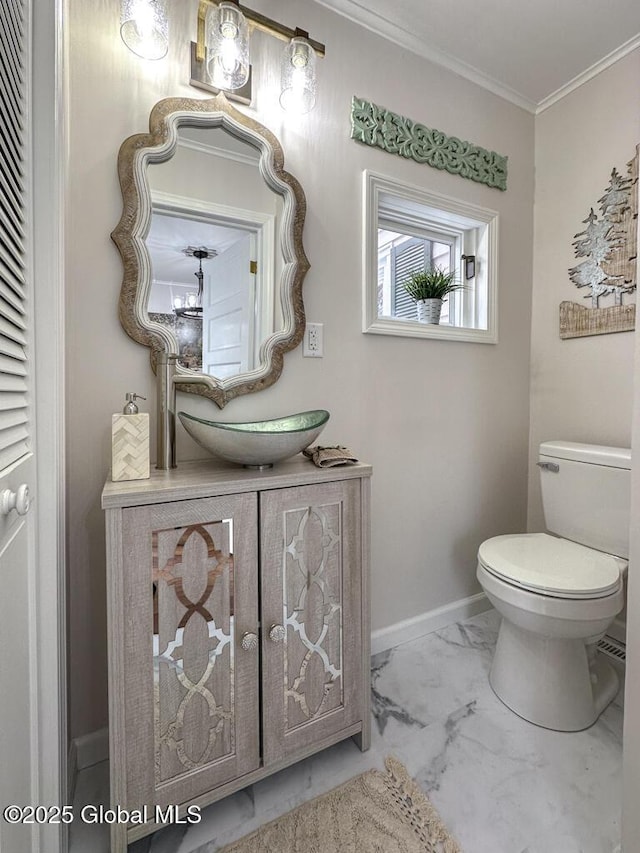 bathroom featuring crown molding, vanity, and toilet