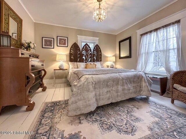 bedroom featuring multiple windows, a chandelier, and ornamental molding