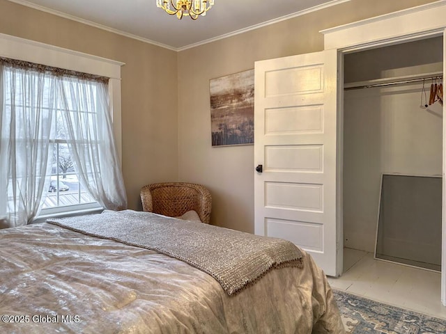 bedroom featuring tile patterned flooring, a closet, crown molding, and a chandelier