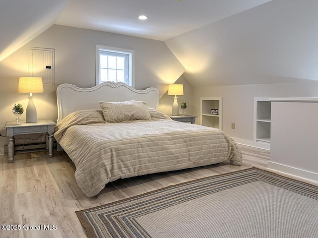 bedroom featuring vaulted ceiling and light hardwood / wood-style floors