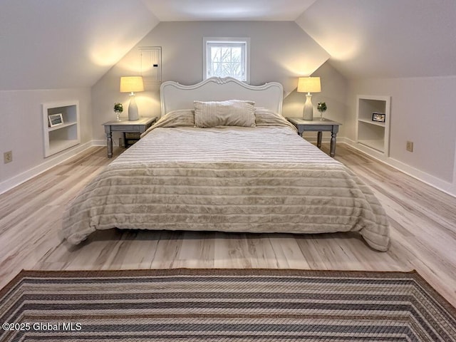 bedroom with lofted ceiling and hardwood / wood-style flooring