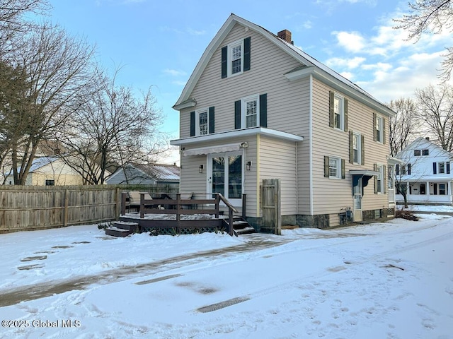 snow covered property featuring a wooden deck