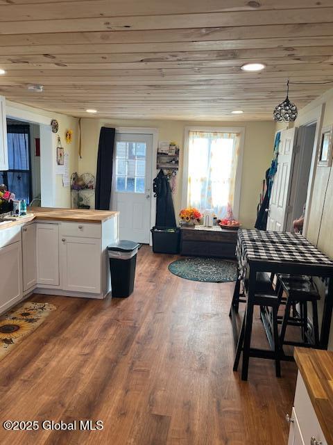 interior space with white cabinets, wooden ceiling, dark hardwood / wood-style floors, and butcher block counters