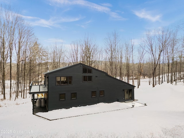 view of snowy exterior featuring a deck