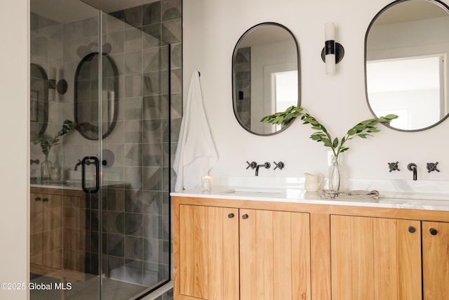 bathroom featuring an enclosed shower and vanity