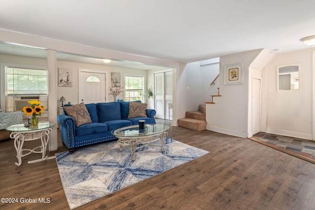 living area with cooling unit, stairs, baseboards, and wood finished floors