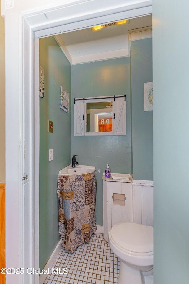 bathroom featuring toilet, tile patterned floors, and vanity