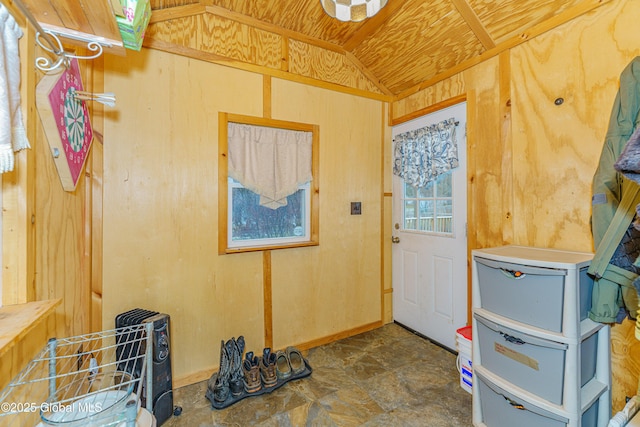 interior space with lofted ceiling, wooden walls, and wood ceiling