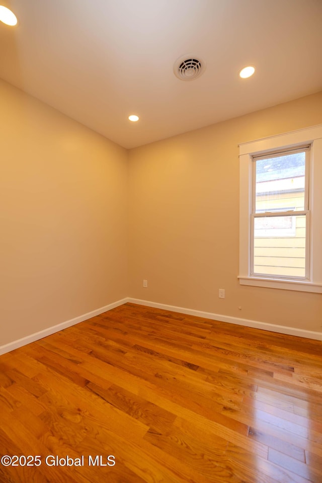 unfurnished room with hardwood / wood-style floors