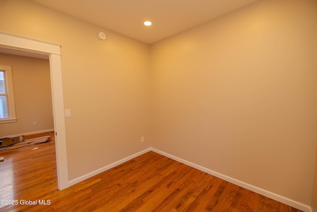 unfurnished room with wood-type flooring