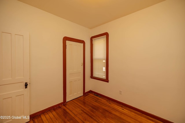 unfurnished room with wood-type flooring