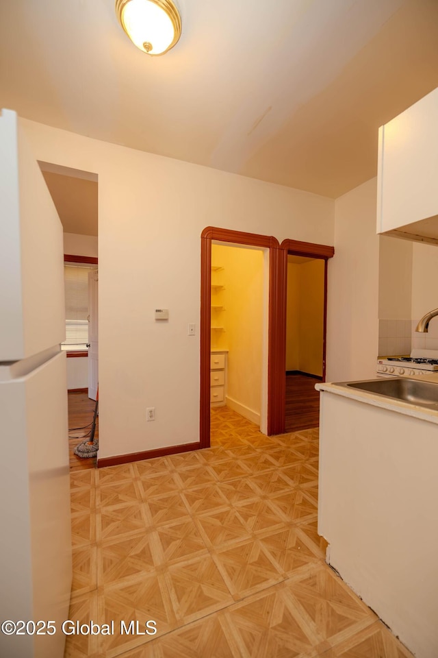 interior space featuring white cabinets and light parquet floors