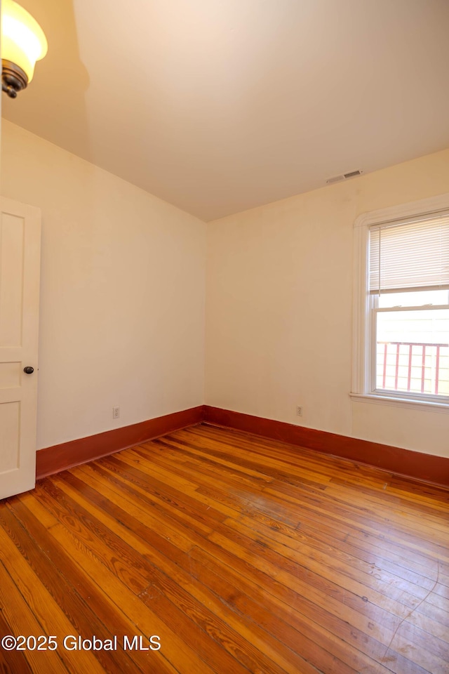 empty room with hardwood / wood-style floors