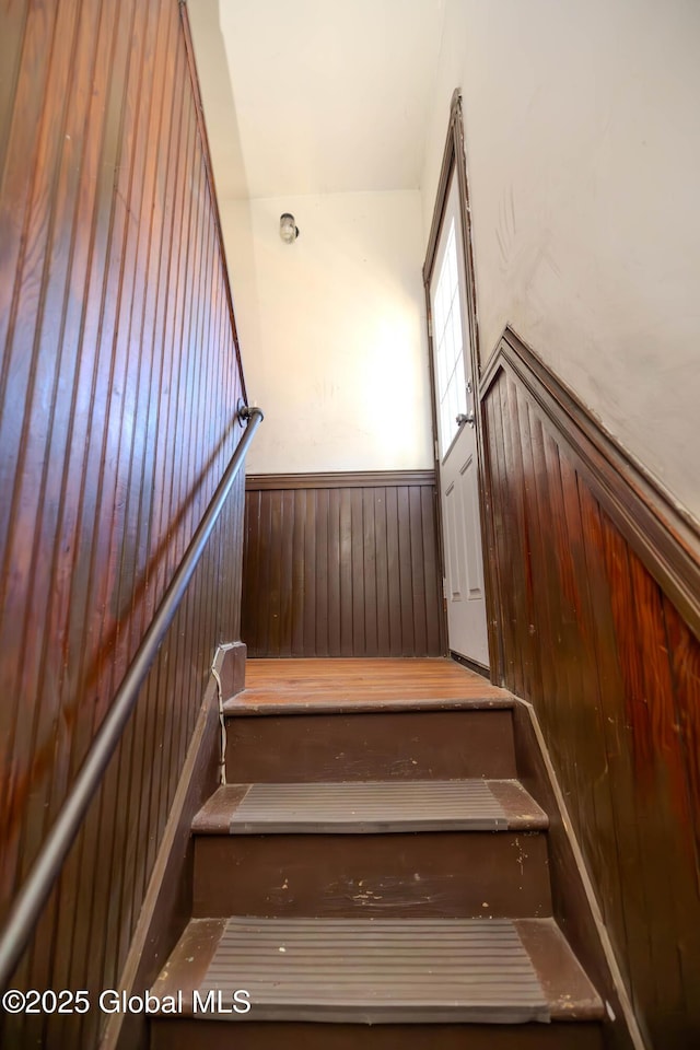 stairs featuring wooden walls