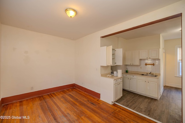 kitchen with sink, white cabinetry, tasteful backsplash, and dark hardwood / wood-style floors