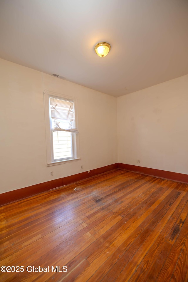 unfurnished room featuring wood-type flooring