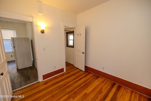 interior space with dark wood-type flooring and multiple windows