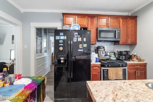 kitchen with stainless steel appliances, crown molding, light stone countertops, and decorative backsplash