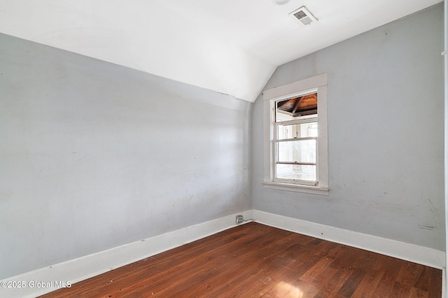 empty room with lofted ceiling and dark hardwood / wood-style floors