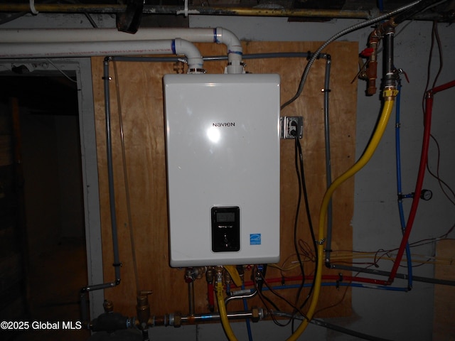 utility room featuring tankless water heater