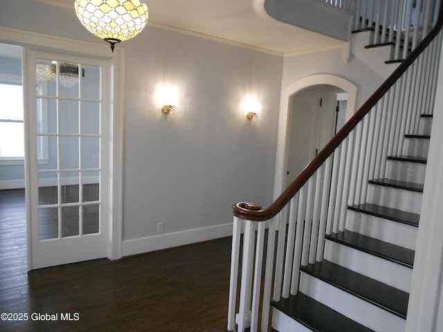 stairs with hardwood / wood-style flooring and crown molding