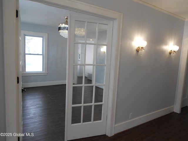 interior space with dark wood-type flooring and a notable chandelier