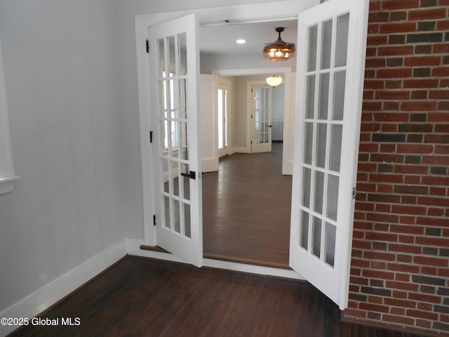 interior space featuring french doors, radiator, and dark hardwood / wood-style flooring