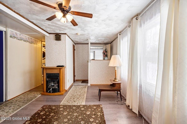 hall featuring stacked washer / drying machine and light hardwood / wood-style floors