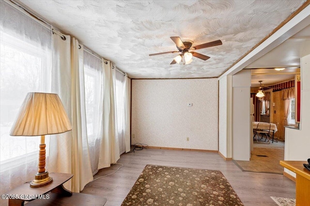 spare room featuring ceiling fan and light hardwood / wood-style flooring