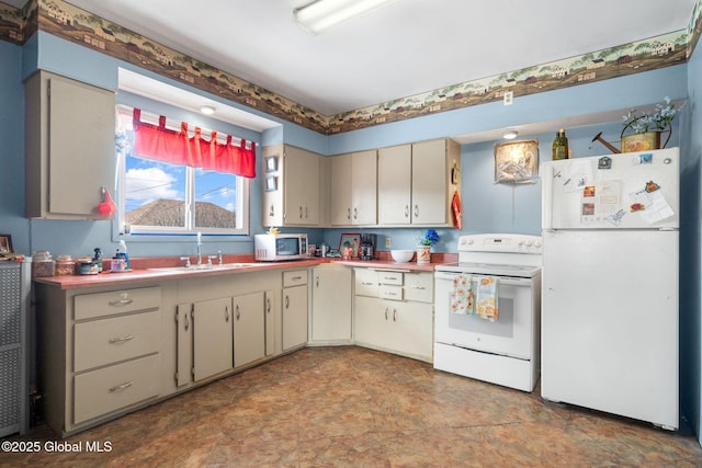 kitchen with sink, white appliances, and cream cabinets