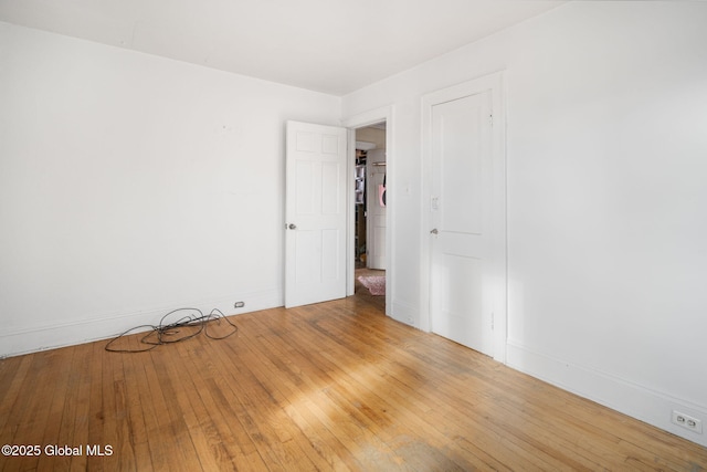 unfurnished room with hardwood / wood-style flooring