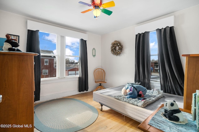 bedroom with ceiling fan and light hardwood / wood-style flooring