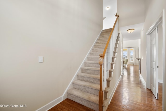 stairs featuring hardwood / wood-style flooring