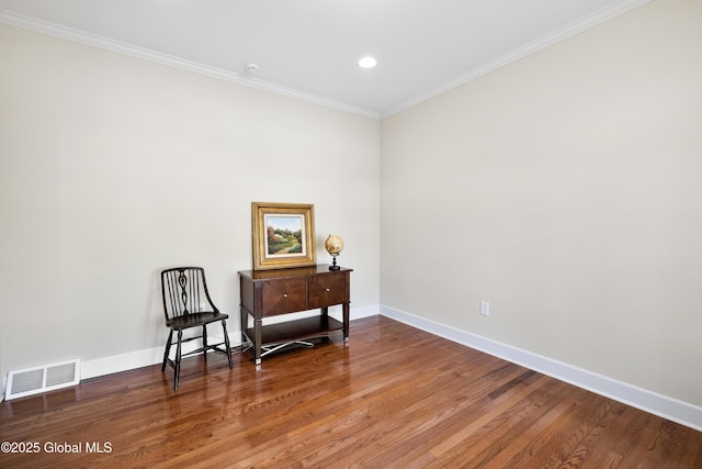 living area featuring crown molding and hardwood / wood-style floors