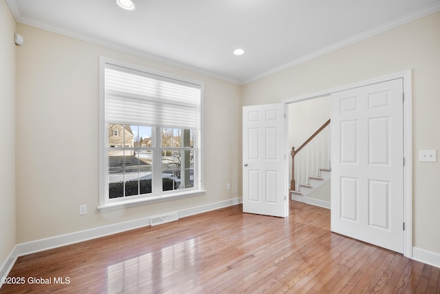 spare room with light hardwood / wood-style floors and ornamental molding