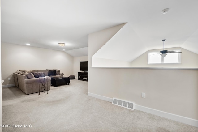 carpeted living room with ceiling fan and lofted ceiling