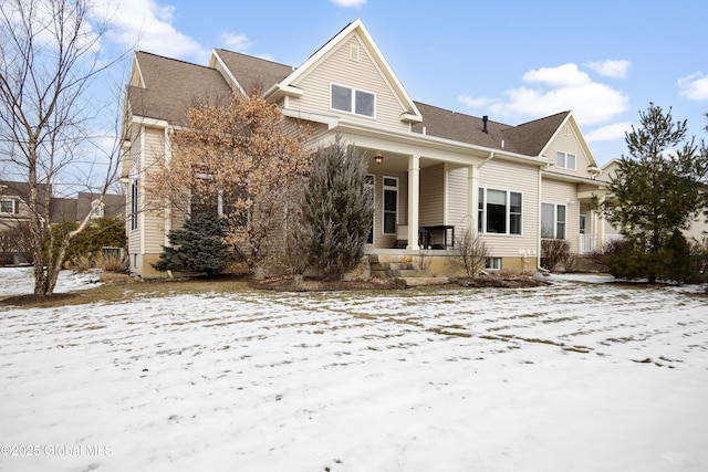 snow covered house with a porch