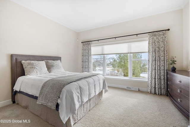 bedroom with light colored carpet and crown molding