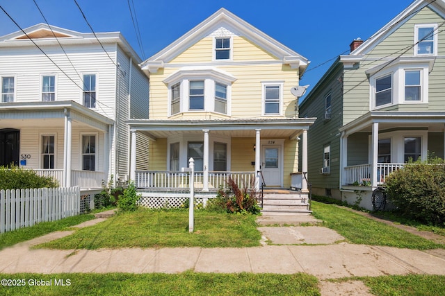 view of front of property with a porch and a front lawn