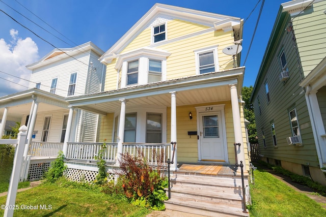 view of front of property with cooling unit and covered porch