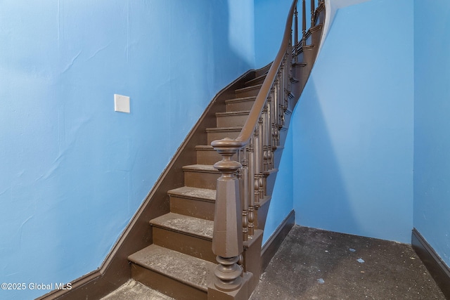 staircase with concrete floors