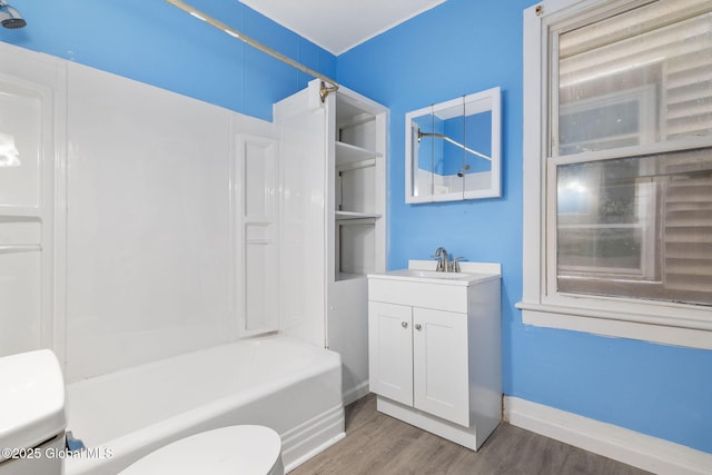 full bathroom featuring toilet, wood-type flooring, vanity, and shower / bathing tub combination