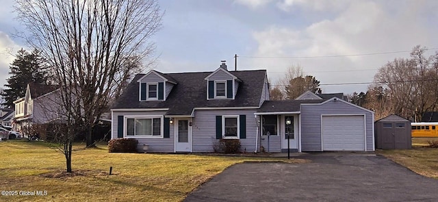 cape cod house featuring a front lawn and a garage