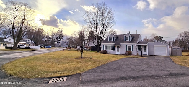 view of front facade with a yard and a garage