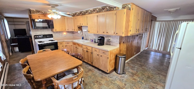 kitchen with white fridge, light brown cabinetry, electric range, and sink