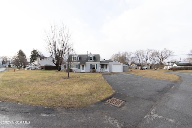 cape cod home with a front lawn and a garage